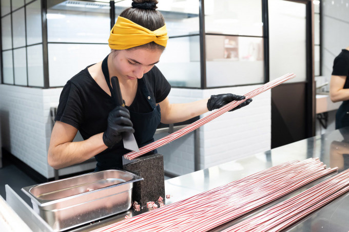 Bonbonmacherin in der Zuckerlwerkstatt stellt Zuckerl her